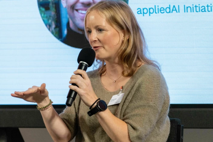 Woman giving a talk at AI conference