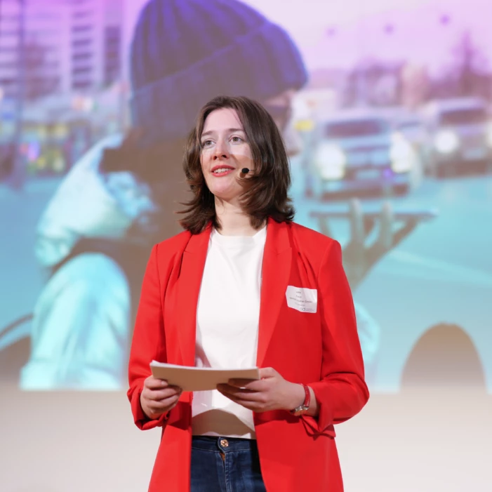 Female applied AI engineer giving a speech